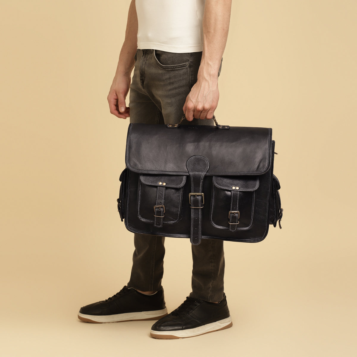 men holding black leather messenger bag 